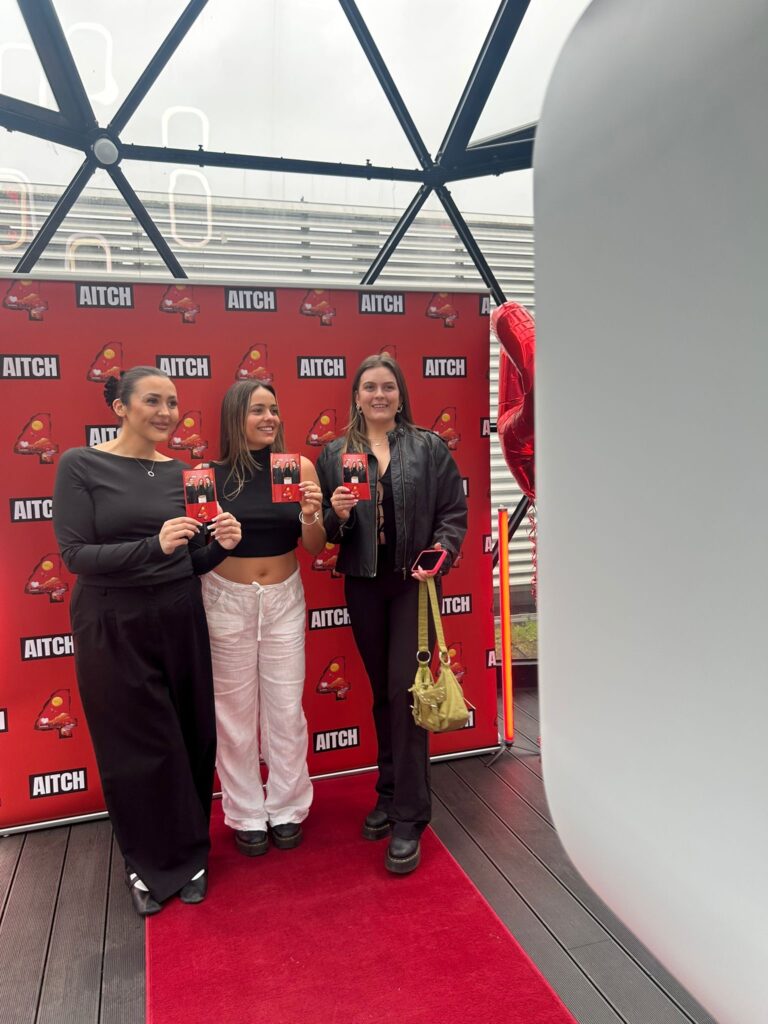 fans holding printout photobooth